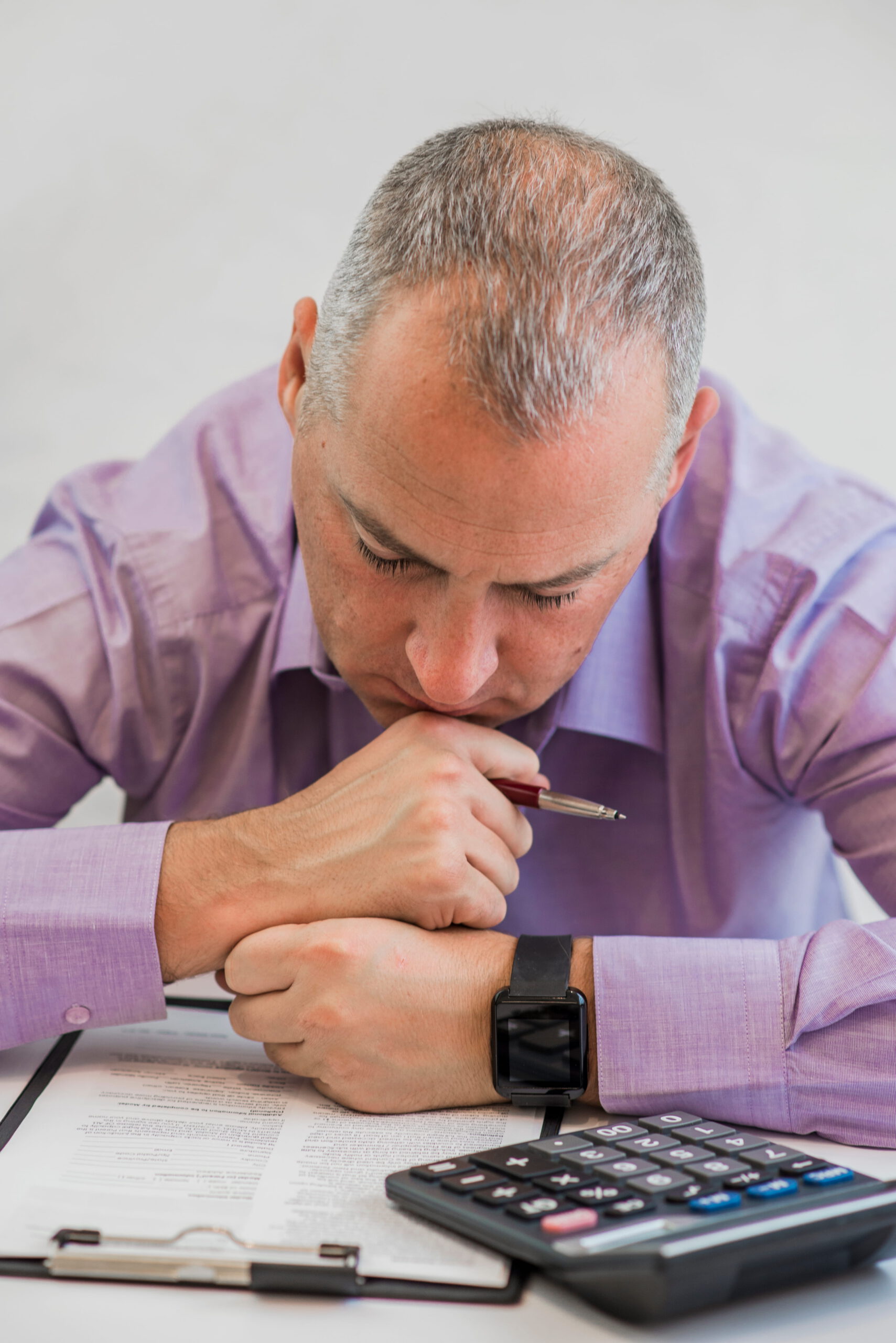 business person thinking hard about tax taxation concept photo young depressed businessman sitting office (1)